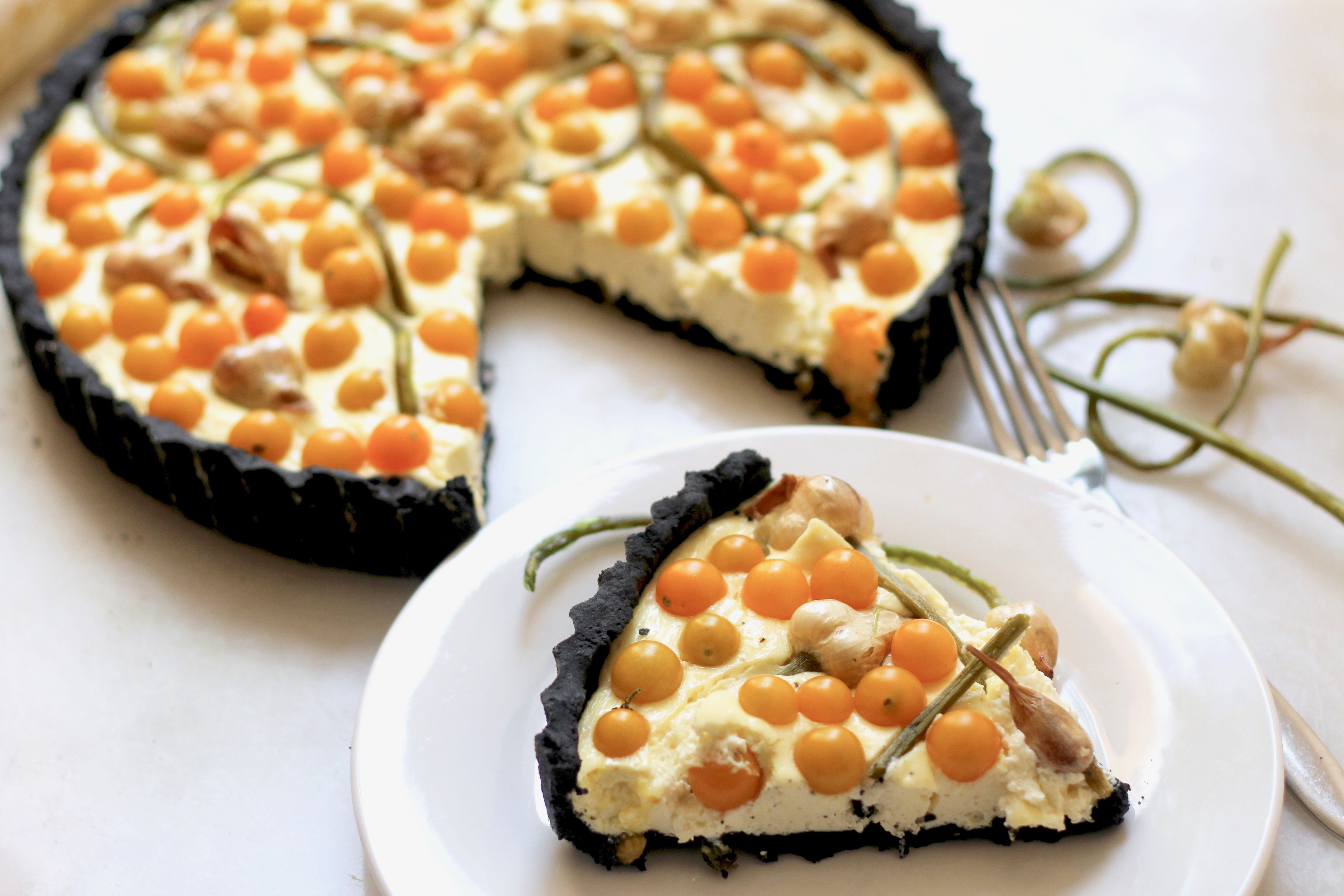 Garlic Scape Currant Tomato Tart in a Charcoal Crust