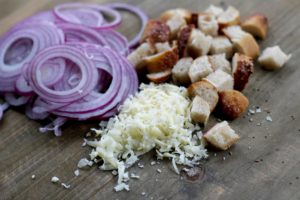 red onion slices, bread cubes, shredded cheese