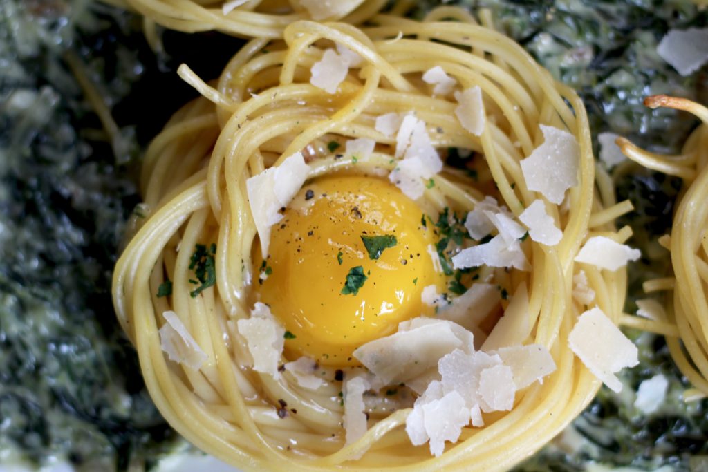 Fried Egg Spaghetti Nests over Homemade creamed Spinach