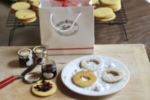 Filling and dipping Linzer Cookies 