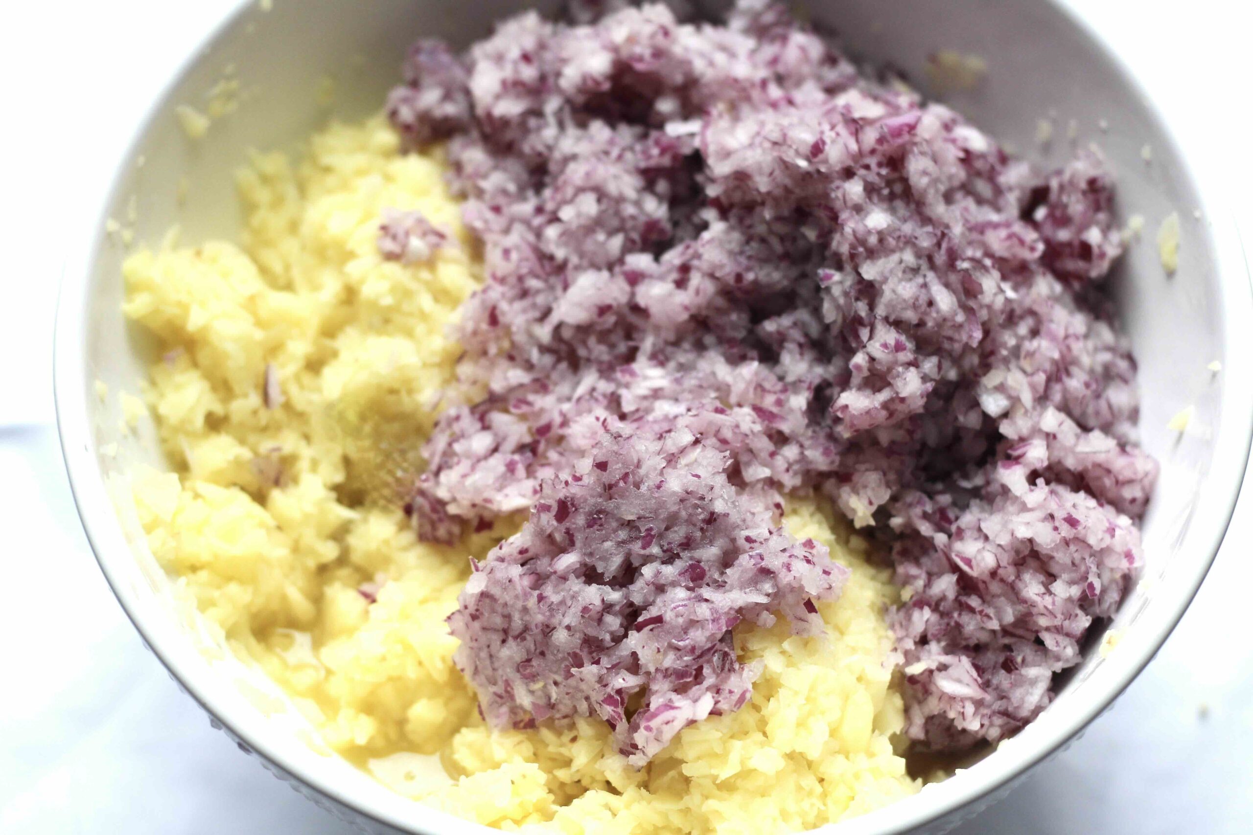 Grated yellow potatoes and red onions