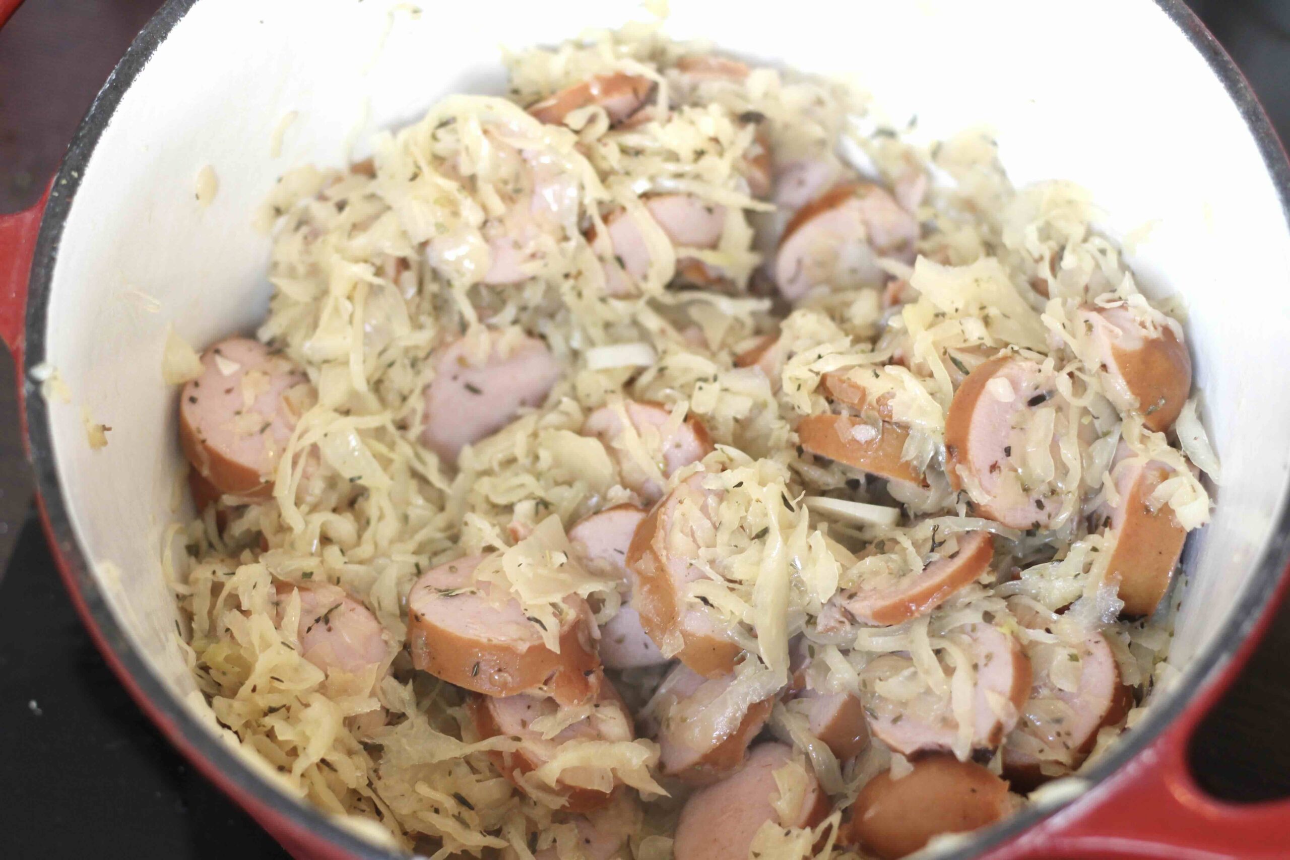 Bratwurst and sauerkraut in a pot